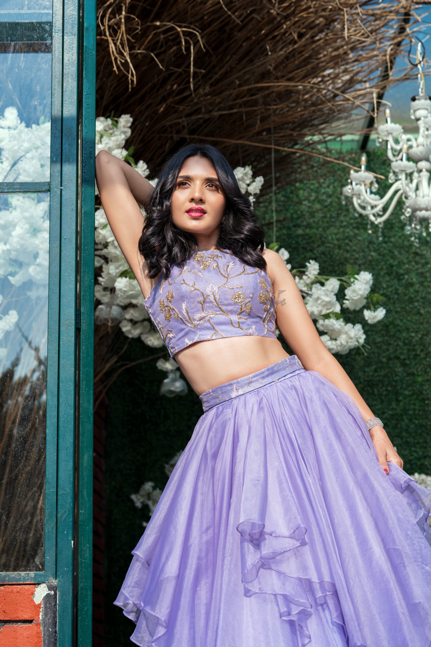 Model wearing a purple designer outfit styled for a fashion shoot, showcasing intricate detailing and contemporary design by shreevaraa design studio